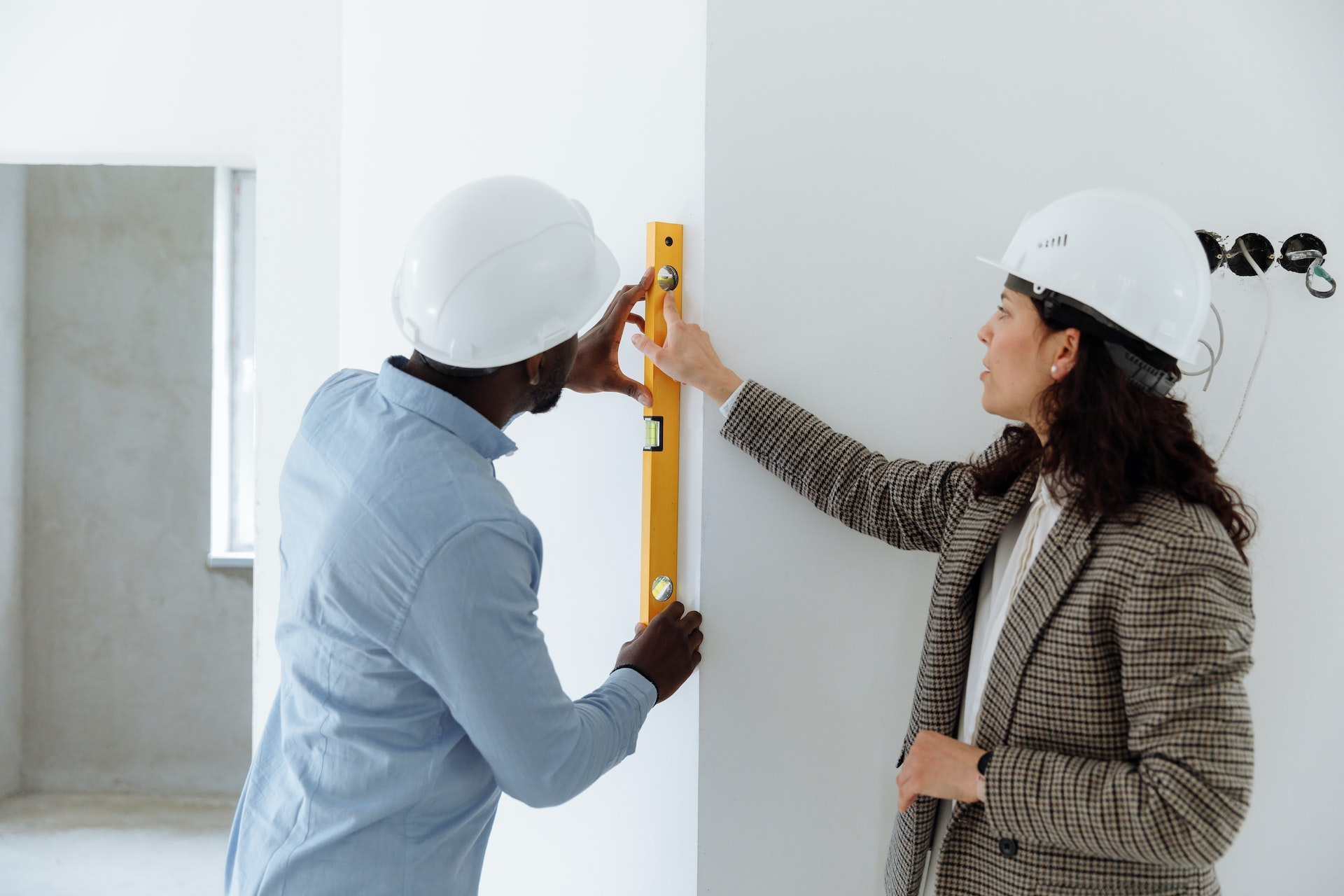 A house with a person pointing at it and a professional rendering it